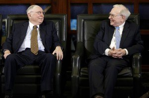 Berkshire Hathaway Chairman and CEO Warren Buffett, right, and his right-hand-man, Charlie Munger, exchange smiles gestures during an interview with Liz Claman on the Fox Business Network in Omaha, Neb., Monday, May 5, 2014. The annual Berkshire Hathaway shareholders meeting concluded the previous weekend. (AP Photo/Nati Harnik)