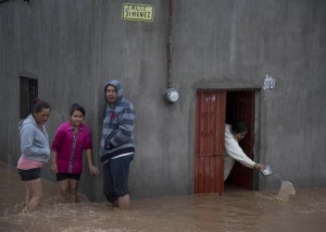 Residents outside a flooded house 150 km northwest of Guadalajara. Hurricane Patricia made landfall on a sparsely populated stretch of Mexico's Pacific coast as a Cat. 5, avoiding direct hits on Puerto Vallarta and the major port city of Manzanillo  (AP Photo/Eduardo Verdugo) 