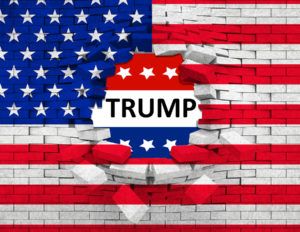 closeup of grunge American USA flag broken crack wall with hole and word trump united states of america vote for president trump concept