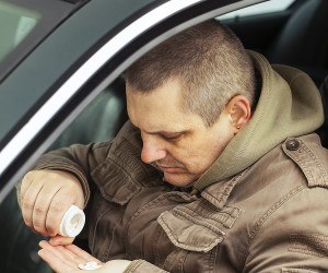 bigstock-Man-sitting-in-car-with-drugs--42326815