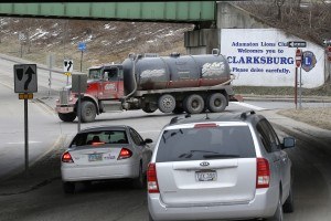 A truck drives through an intersection in Clarksburg, W. Va. In March of 2013, a truck carrying drilling water overturned near the same intersection onto a car driven by Lucretia Mazzei, killing her two sons. An analysis of traffic fatalities in the busiest new oil and gas-producing counties in the U.S. shows a sharp rise in deaths that experts say is related to the drilling boom. (AP Photo/Keith Srakocic)