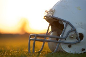 American Football Helmet on the Field at Sunset with room for co
