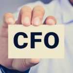 CFO letters (or Chief Financial Officer) on the card held by a man hand vintage tone