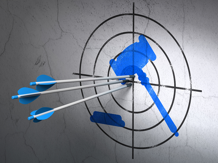 Success law concept: arrows hitting the center of Blue Gavel target on wall background