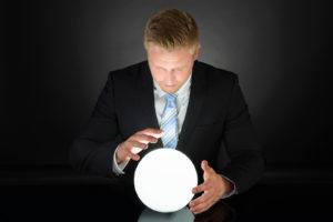 Portrait Of Businessman Predicting Future With Crystal Ball