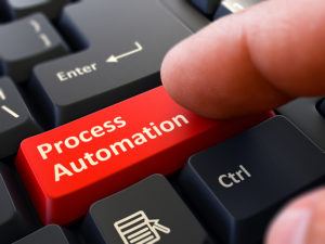 Process Automation Button. Male Finger Clicks on Red Button on Black Keyboard. Closeup View. Blurred Background. 3D Render.