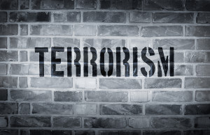Terrorism stencil print on the grunge white brick wall